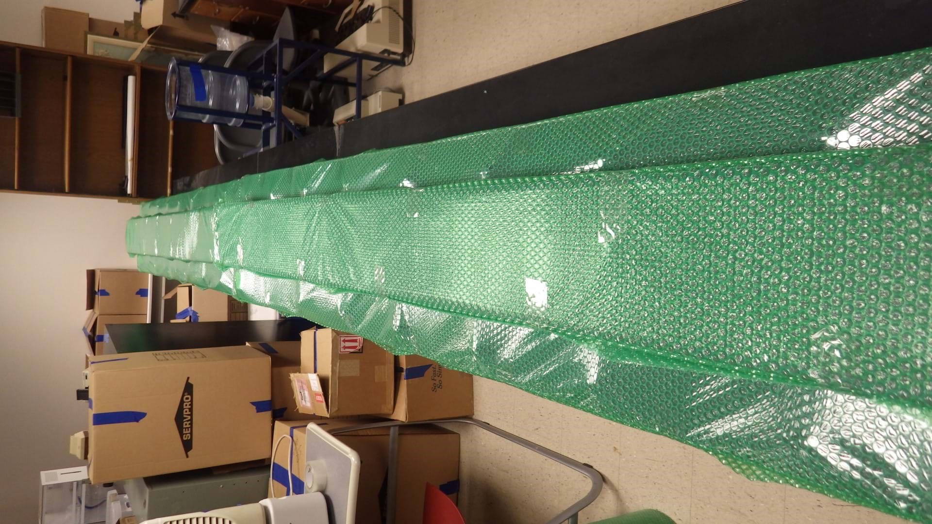 8 Photo Of Completed LED Ticker Bars Individually Wrapped In Protective Bubble Wrap And Stored Off The Floor On A Benchtop. It Is Important That These Are Handled With Care When Moving And Avoid Stacking Anything
